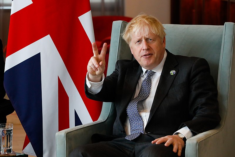 Boris Johnson giving a V-sign hand gesture