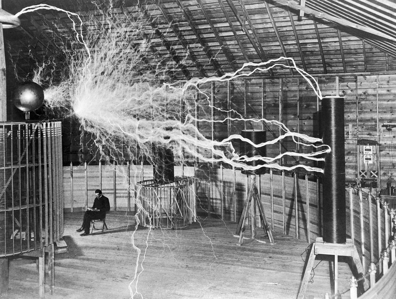Nikola Tesla in his lab with his equipment