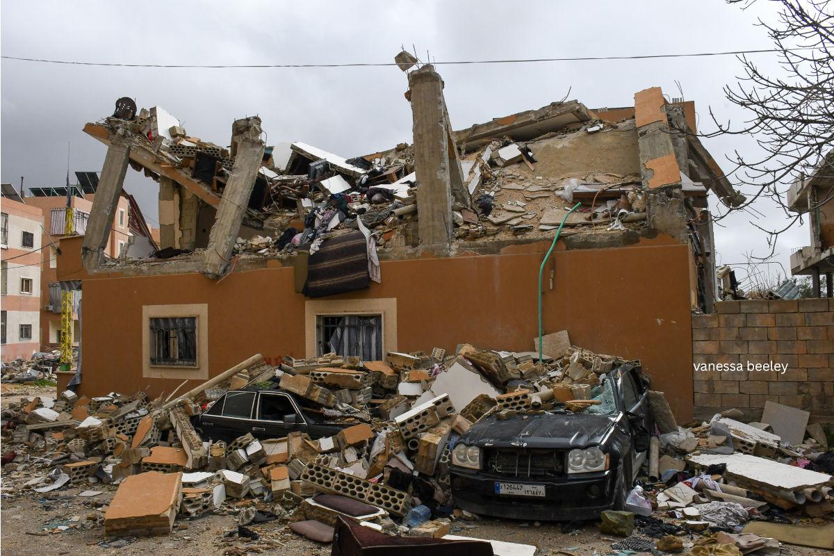 Cars buried under the rubble of the Zionist airstrike