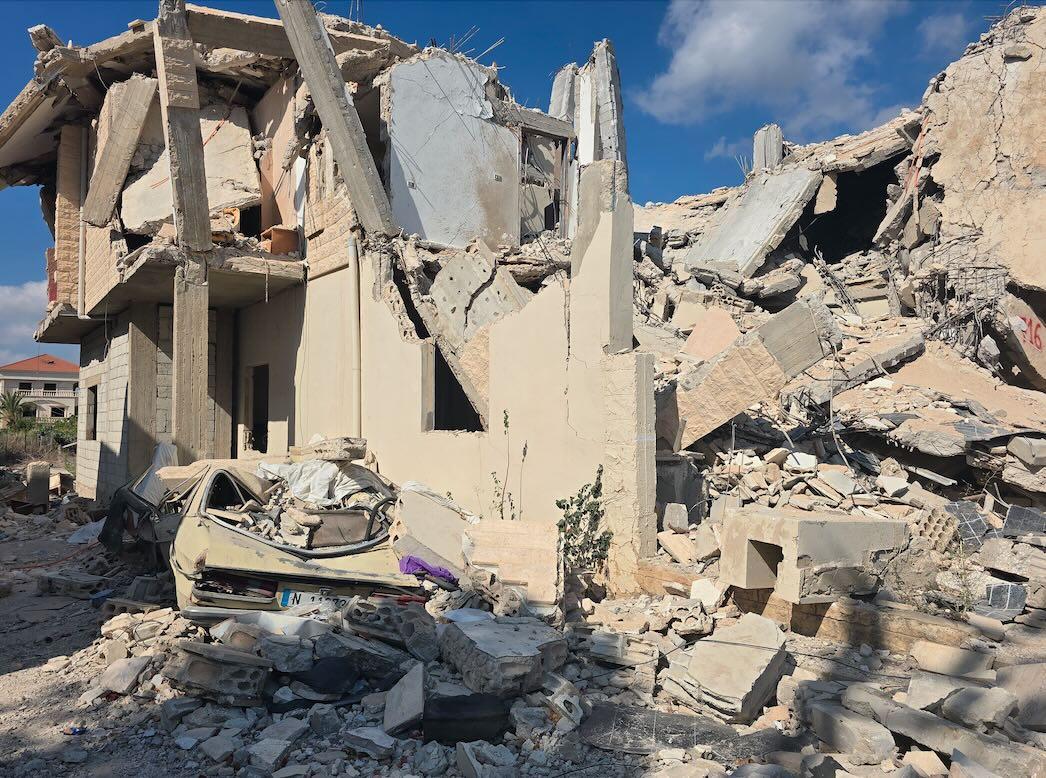 A collapsed residential home and burned-out vehicle in the village of Qlaileh, southern Lebanon, after an Israeli attack. Photo: Roqayah Chamseddine