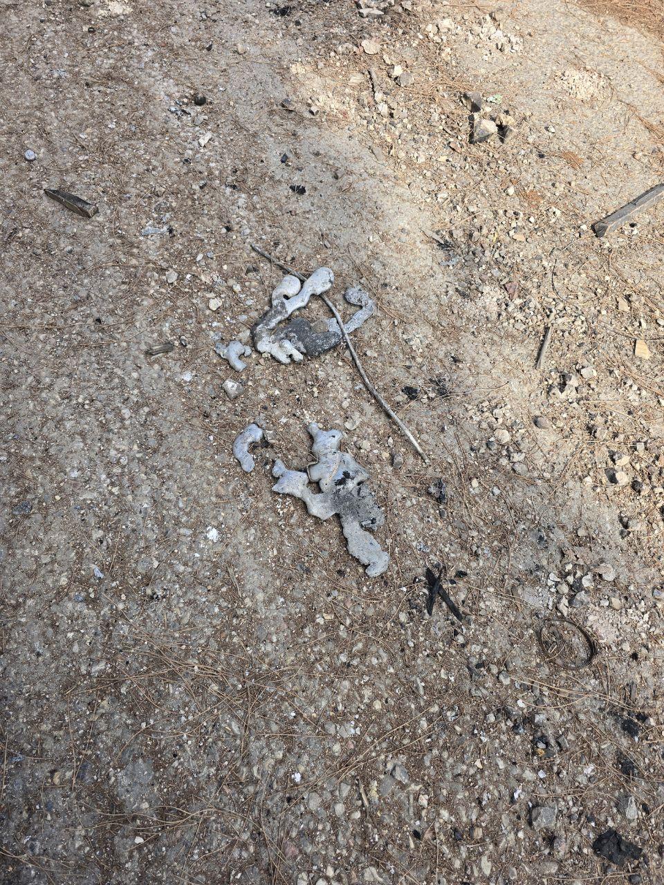Parts of a melted light pole near Ghandour Hospital